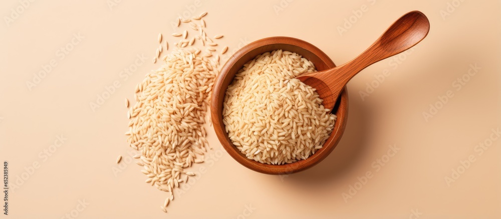 Aufkleber brown rice in wooden bowl on a isolated pastel background copy space front view naturally nutritious