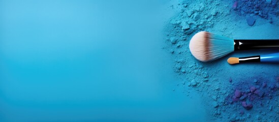 blue eyeshadows and makeup brush isolated pastel background Copy space