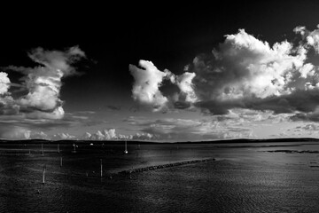 dramatic clouds over the sea in black and white
