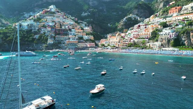 Positano, tourist destination on the Amalfi Coast, Italy. Aerial view of Colorful houses on a Tyrrhenian sea coast seen through green juicy flora in Positano is a village in Naples metropolitan area
