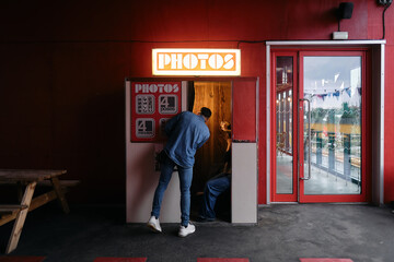 Person entering the photobooth with more people inside
