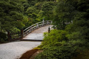 Fototapeta na wymiar The entrance to a beautiful bridge spanning a pond on the castle grounds in Kyoto, Japan.