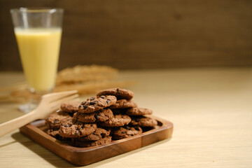 Homemade Chocolate Chip Cookies above Wooden Table, Served with a Bottle of Milk. Bakery Concept with Copy Space for Text