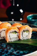 sushi rolls for advertising in an expensive restaurant on blue plates