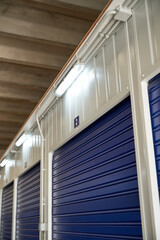 Row of blue roller shutters in modern warehouse