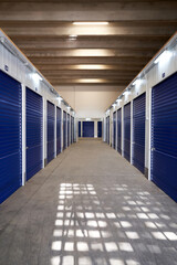Long narrow corridor with storage in an industrial building for rental