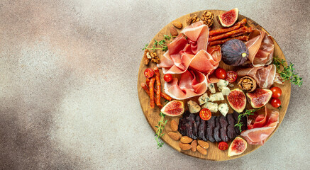 Appetizers table with different antipasti on a light background. Long banner format. top view