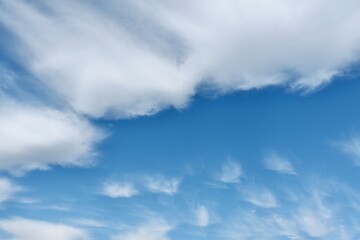 Vivid white cirrus clouds against the blue sky. Horizontal photo