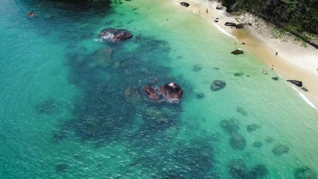 beach with crystal clear waters island in Brazil stones white sand aerial drone view