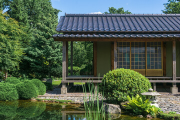 japanese garden with a pond, zigzag bridge and a tea house