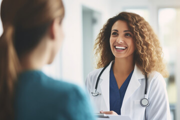 A female doctor discusses with a smiling patient in a hospital, reflecting a positive and compassionate healthcare interaction.