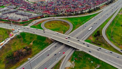 Aerial view of freeway intersection. Clip. Highway and overpass with cars and trucks, interchange, two-level road junction in big city. Top view traffic concept freeway interchange carry heavy traffic