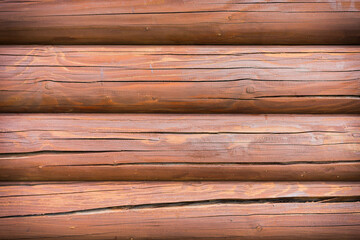 Texture of a red impregnated building wall made of pine logs