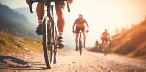 Team of cyclists rides on mountain road,  at sunset - obrazy, fototapety, plakaty