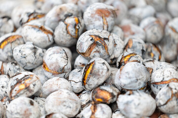 Savory roasted chestnuts, sprinkled with salt, in a rustic setting.