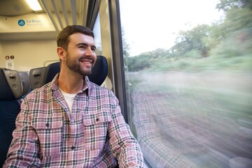 Handsome man sitting on train