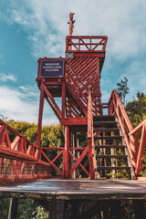 red wooden observation platform in the woods of chiloe