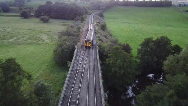 Glaisdale, United Kingdom - August 31st, 2023 - Aerial footage of a passenger train just past Glaisdale station.