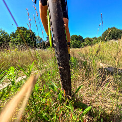 a bicycle in motion, a view of the wheel, on the background of a field with grass