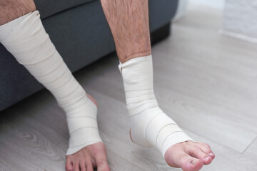 man using put on elastic bandage with legs having leg pain
