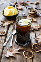 Vintage glass cup in holder  with  tea on wooden table