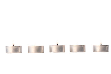 five burning tea lights in aluminum bowls