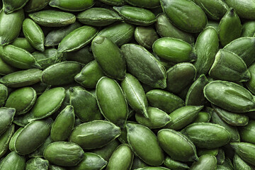 Pumpkin seeds, peeled green, in bulk close-up, top view