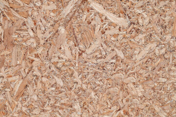 Chipboard plywood, surface close-up, uniform texture background, glued wood chips