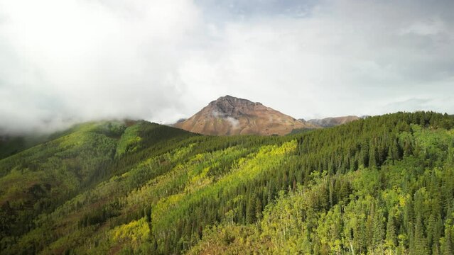 Aerial of Teocalli Mountain in Crested Butte Colorado with fall colors and low clouds