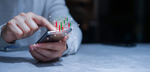 close up young investor man hand use smartphone to trade on stock market on exchange platform for...