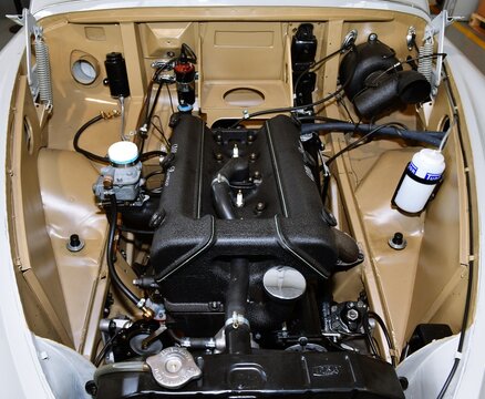 the engine of a vintage Alfa Romeo italian car repaired and repainted