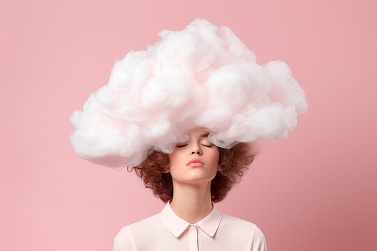 a young woman with her head in pink cloud on a pastel pink background
