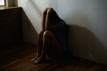 Silhouette low key dark shadow of young woman feeling sad upset or scared protecting from domestic sexual violence harassment, human trafficking. Woman abuse sexual harassment international woman day.