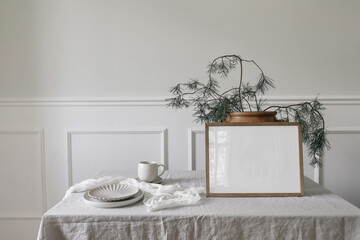 Elegant Christmas interior. Winter artistic composition. Blank horizontal wooden picture frame...