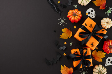 Sharing Halloween warmth through well-chosen presents. Top view photo of presents with ribbons,...