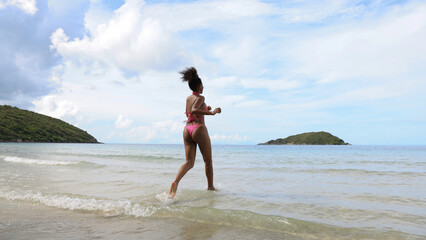 The happy  black girl run to the sea on sea at tropical beach, Summer vacation