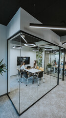 Young business women discussing in cubicle at the office