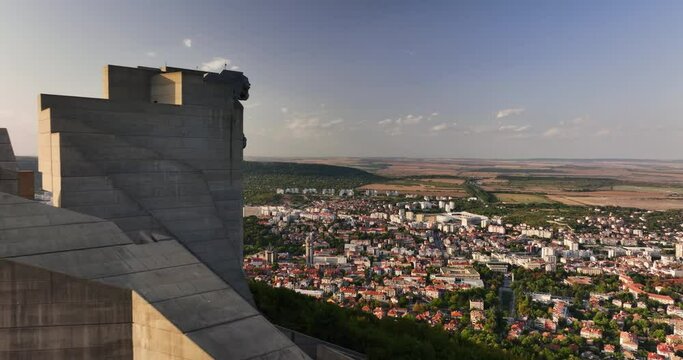 Aerial view of colossal monument 1300 years Founders of the Bulgarian State in Shumen, Bulgaria and aerial panorama view of city and mountain landscape