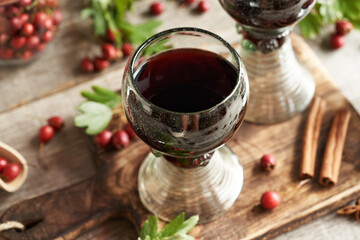 Medicinal wine made of fresh hawthorn berries in vintage glass cups