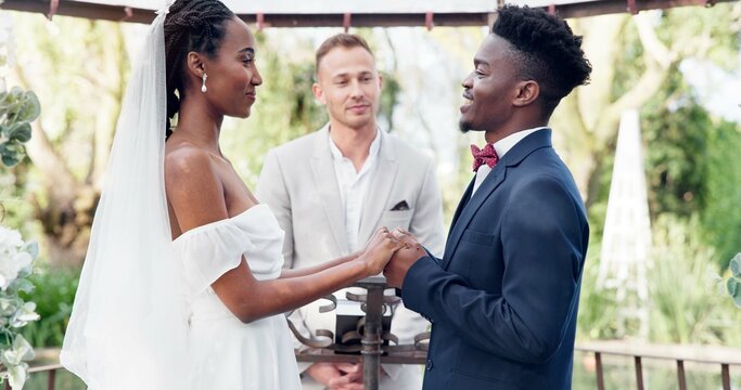 Happy black couple, wedding and vows in marriage, commitment or support together at alter. Married African woman and man holding hands for love, trust or speech of bride or groom in outdoor romance