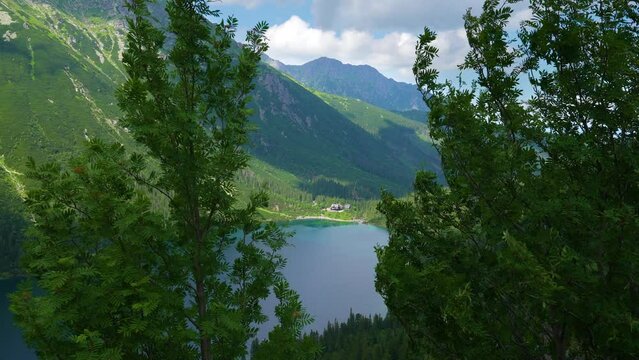 Aerial Famous view of mountains lake morskie oko or sea eye lake in summer day. Beautiful sky sunlight above Tatras lake landscape. UNESCO's World Network of Reserves. Tatra national park, Poland.