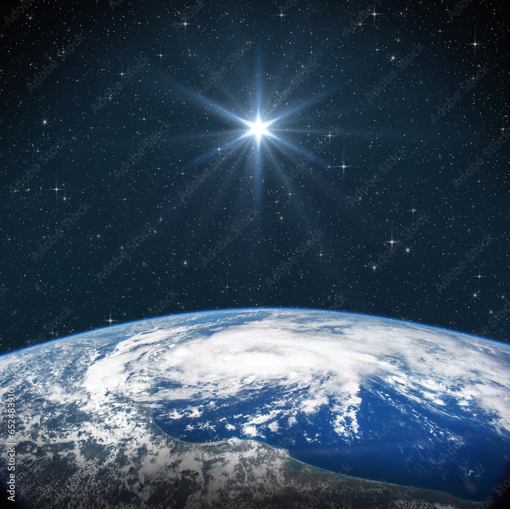 Wall mural bright star shines above the earth in starry space. birth of jesus concept, star of bethlehem. eleme