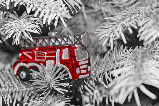Red fire truck hanging on Christmas tree as decoration