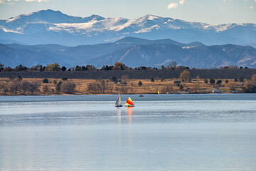 A peaceful Autumn day at Cherry Creek State Park in Colorado, with Sailboats on the lake and the...