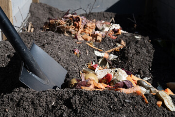 Shovel and bokashi compost. Pre-fermented food waste to be added to the soil in the garden bed....