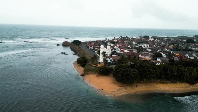 cinematic aerial footage of the renowned Galle Fort, a historic fortress and iconic lighthouse landmark located in Galle, Sri Lanka, Asia