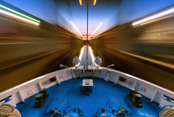 Cruise steamship passes through the gateway of the Moscow Canal at sunset, long exposure