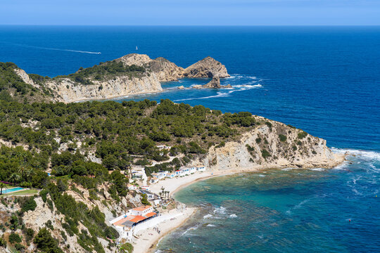 High angle view of beautiful Cala del Portitxol beach, Cap Prim cape and turquoise sea in Javea, Spain.