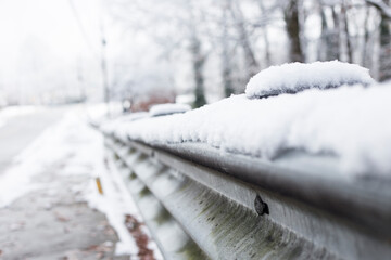 Snow covered road guard rail