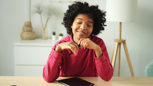 Happy african american teen girl blogger smiling face talking to webcam recording vlog. Social media influencer woman streaming making video call at home. Headshot portrait selfie webcamera view